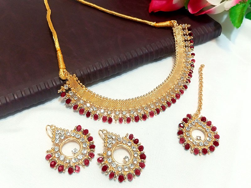 Elegant Red Stones Golden Jewelry Set with Earrings & Tikka