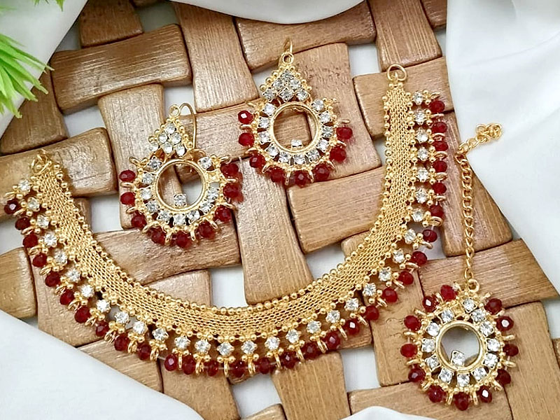 Elegant Red Stones Golden Jewelry Set with Earrings & Tikka Price in Pakistan